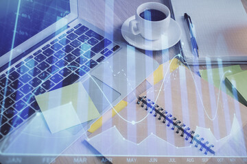 Multi exposure of forex graph drawing and desktop with coffee and items on table background. Concept of financial market trading