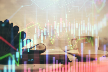 Double exposure of financial chart drawing and desktop with coffee and items on table background. Concept of forex market trading