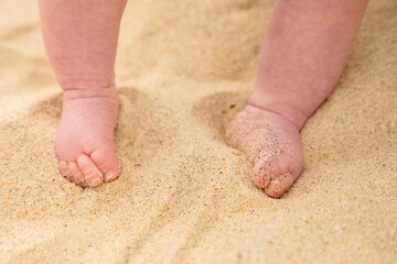 Baby barefoot feet on the sand
