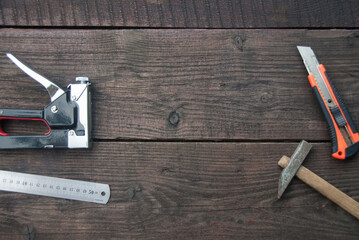 Building tools on the dark wooden table. Top view, flat lay. Copy space