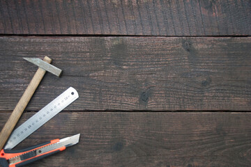 A set of a building tools on dark wooden panel background. Copy space. Flat lay