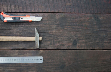 Flat lay of a building tools on a dark wooden table. Woodwork and DIY concept. Copy space