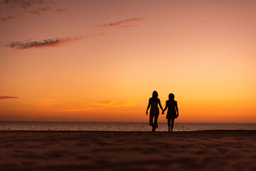 Fototapeta premium Los Cabos / Mexico- Feb 2019 Lesbian Love concept, sunset Lesbian, adjective to characterize or associate nouns with female homosexuality or same-sex attraction.