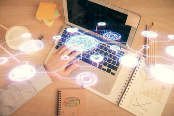 Double exposure of man's hands typing over computer keyboard and social network theme hologram drawing. Top view. People connection web concept.