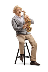 Elderly man musician playing a sax and sitting on a chair