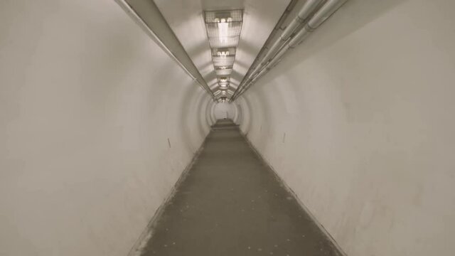Montreal, QC, Canada - November 15, 2017: Walking on pedestrian underground tunnel, linking Herron Rd and Cardinal Ave, under highway Autoroute 20.