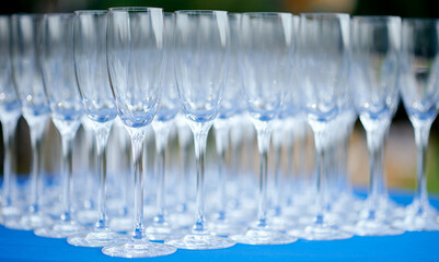 A glass filled with wine glasses on blue table