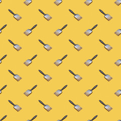 paintbrush seamless pattern isolated on a yellow background. creative concept. texture backdrop. design and decoration