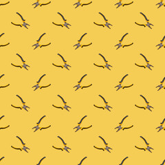 pliers seamless pattern over yellow background. work tool concept. equipment texture.