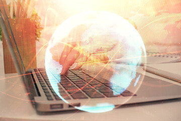 Double exposure of woman hands typing on computer and business theme hologram drawing. Success concept.