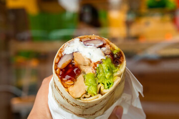 Mexican traditional authentic homemade Burrito with pulled pork beef chili con carne serve with tomato salad and avocado guacamole and dip sauce