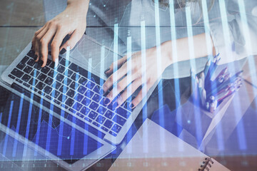 Double exposure of woman hands typing on computer and forex chart hologram drawing. Stock market invest concept.