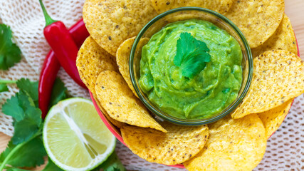 Mexican authentic homemade Guacamole with corn nachos chip traditional fresh healthy appetizer dip sauce for vegan