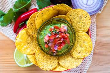 Mexican authentic homemade Guacamole with corn nachos chip traditional fresh healthy appetizer dip sauce for vegan
