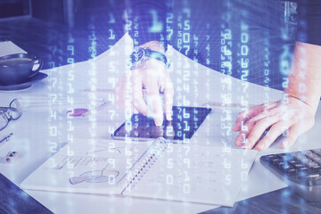 Double exposure of man's hand holding and using a digital device and data theme drawing. Technology concept.
