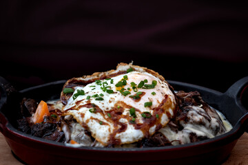 Beef bourguignon - beef stew braised in red wine, often red Burgundy, and beef stock, generally flavoured with carrots, onions, garlic, and a bouquet garni, pearl onions, mushrooms, and an egg.