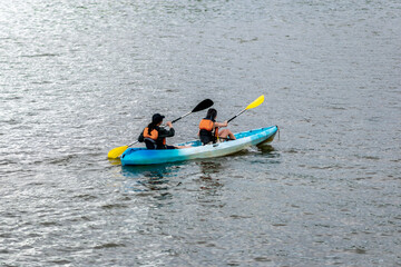 Tourists kayaking on the Potomac River with colorful kayaks in a sunny summer day near Washington,...