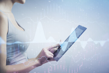 Double exposure of forex chart sketch hologram and woman holding and using a mobile device. Stock market concept.