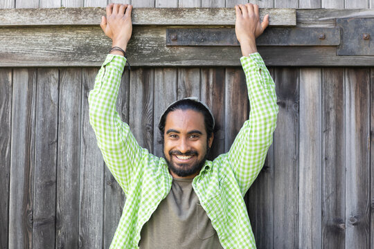 young man in front of a wooden door