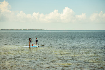 Photo of women on standup paddleboards SUP Miami Key Biscayne