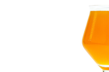 Cold beer in a Teku tasting glass filled to full with foam, drops of water on glass, half glass visible on the right, isolated on a white background with a clipping path.