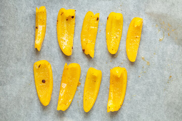 Bright slices of bell pepper prepared for baking in the oven. Soft focus.