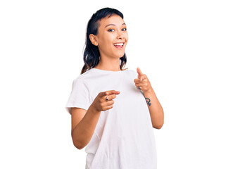 Young woman wearing casual clothes pointing fingers to camera with happy and funny face. good energy and vibes.