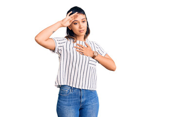 Young woman wearing casual clothes touching forehead for illness and fever, flu and cold, virus sick