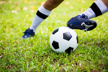 Soccer player control to shoot ball on green grass to goal. Soccer player training for match....