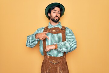 Young handsome man wearing tratidional german octoberfest custome for Germany festival In hurry...