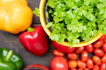 Vegetables on a wooden table. Parsley, pepper, tomato juice