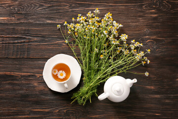 Healthy chamomile tea on wooden background