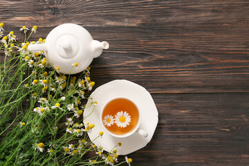 Healthy chamomile tea on wooden background