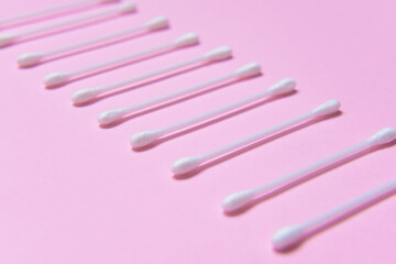 Cotton cosmetic swabs on color background