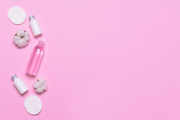 Cotton flowers with cosmetics and pads on color background
