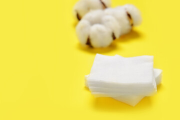 Cotton cosmetic pads on color background