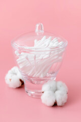 Cotton cosmetic swabs on color background