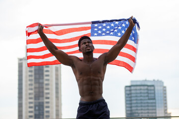 african american man with usa flag protests and shouts showing aggression on the street, activist...