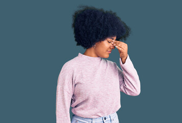 Young african american girl wearing casual clothes tired rubbing nose and eyes feeling fatigue and headache. stress and frustration concept.
