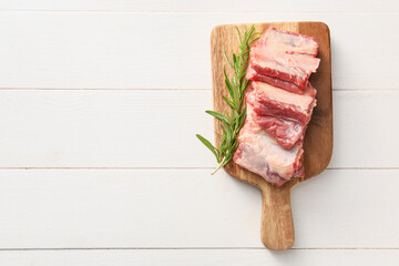 Raw beef short ribs with herbs on table