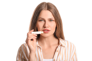 Beautiful young woman with lip balm on white background