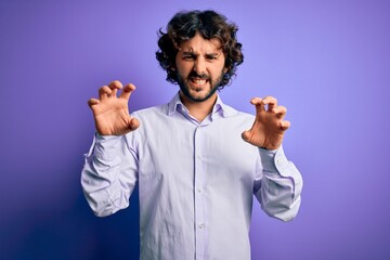 Young handsome business man with beard wearing shirt standing over purple background smiling funny...