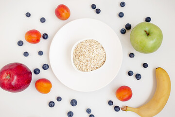 breakfast stilllife with cereals and fruits on white background
