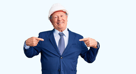 Senior handsome grey-haired man wearing suit and architect hardhat looking confident with smile on face, pointing oneself with fingers proud and happy.