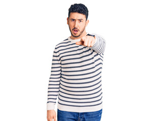 Fototapeta premium Young hispanic man wearing casual clothes pointing displeased and frustrated to the camera, angry and furious with you
