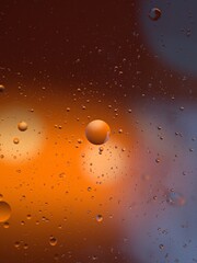 Closeup orange bubbles oil with soft focus and blurred background ,macro image ,abstract background ,water droplets, soap bubbles ,sweet color for card design water drops on glass