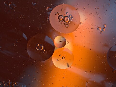 Closeup orange bubbles oil with soft focus and blurred background ,macro image ,abstract background ,water droplets, soap bubbles ,sweet color for card design water drops on glass