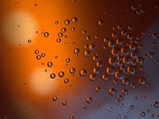 Closeup orange bubbles oil with soft focus and blurred background ,macro image ,abstract background ,yellow gold water droplets, soap bubbles ,sweet color for card design water drops on glass