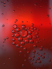 Closeup red bubbles oil with soft focus and dark blurred background ,macro image ,abstract background , water droplets, soap bubbles ,sweet color for card design water drops on glass