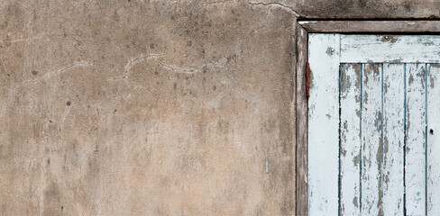 Old wooden plank door with concrete wall